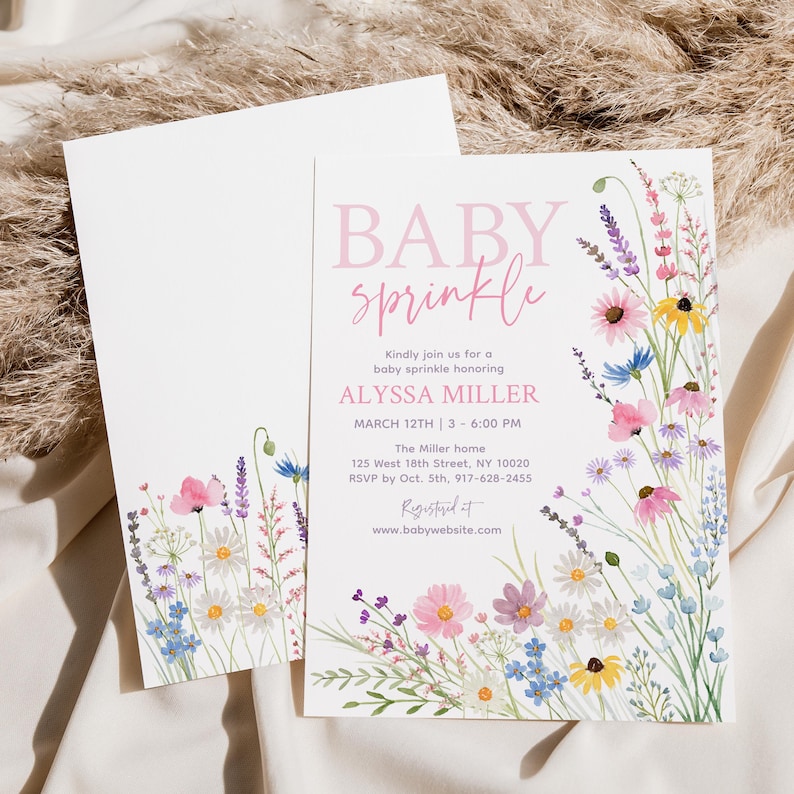 May include: Baby sprinkle invitation with floral watercolor design. The invitation features the text "BABY sprinkle" in pink script, along with event details. A matching envelope is included, both with floral accents.