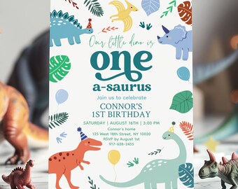 May include: A white invitation card with colorful dinosaur illustrations and the text "Our little dino is one a-saurus." The card announces Connor's 1st birthday, including date, time, and location. Decorative elements include balloons and leaves.