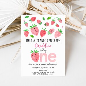 May include: A pink and white birthday invitation with a watercolor illustration of strawberries. The text reads "Berry Sweet and So Much Fun Madeline is turning one. Join us for a sweet celebration! Saturday, July 16th, 6:00 PM. Madeline's home, 125 West 18th Street, New York, NY 10020. RSVP to 917-628-2455 call or text."