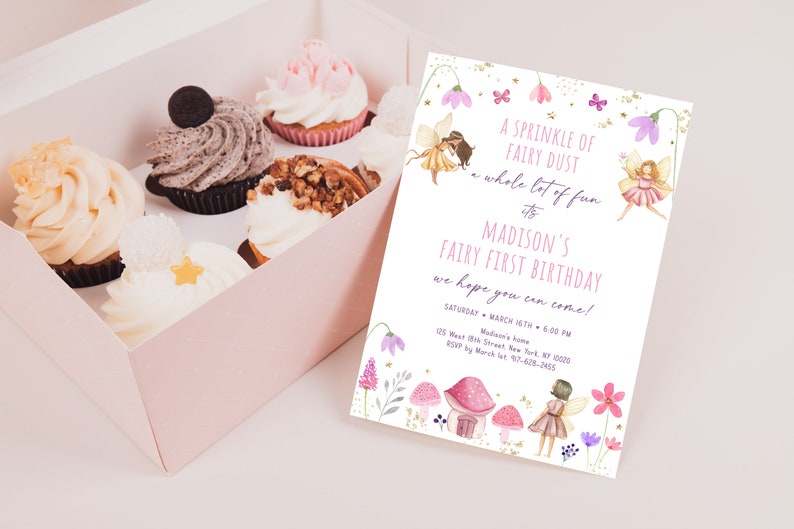 May include: A pink box filled with cupcakes and a matching invitation. The invitation reads "A Sprinkle of Fairy Dust" and announces Madison's Fairy First Birthday. Cupcakes have various toppings.