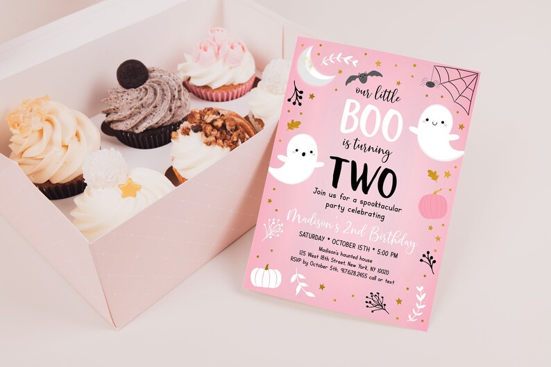 May include: Pink Halloween birthday invitation with a ghost and the text "our little BOO is turning TWO". The invitation has a gold glitter background and features a pumpkin, spider web, and bats.