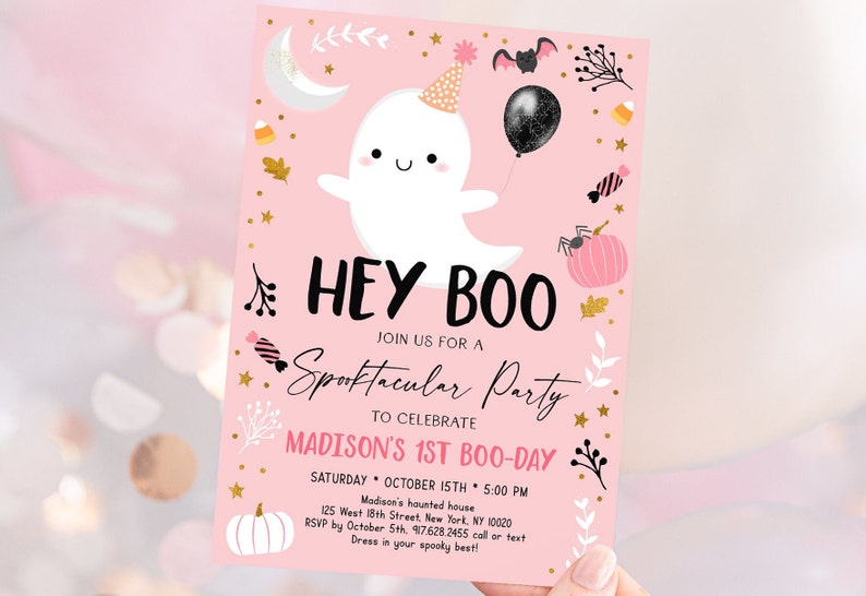 May include: Pink and gold Halloween party invitation with a cute ghost illustration, the text "Hey Boo", and the words "Spooktacular Party" in cursive. The invitation includes details for a first birthday party, including the date, time, and location.