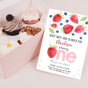 May include: A pink and white birthday invitation with a watercolor illustration of strawberries and blueberries. The text reads "Berry Sweet and So Much Fun Madison is turning one. Please join us to celebrate! Saturday, July 16th, 6:00 PM, 125 West 8th Street, New York, NY 10020, RSVP to 917-628-2465 call or text."