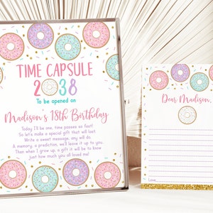 May include: A printable time capsule sign with a donut theme. The sign says "Time Capsule 2038 To be opened on Madison's 18th Birthday". The sign is decorated with pink, purple, and blue donuts with sprinkles.