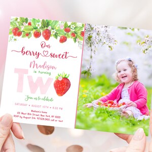May include: A two-sided birthday invitation with a strawberry theme. The front features the text "Our berry sweet Madison is turning Two" with a strawberry illustration. The back shows a photo of a smiling child with strawberries.