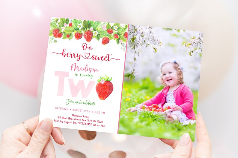 May include: A two-sided birthday invitation with a strawberry theme. The front features the text "Our berry sweet Madison is turning Two" with a strawberry illustration. The back shows a photo of a smiling child with strawberries.