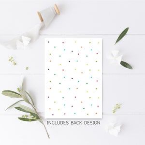 May include: A white card with a colorful polka dot pattern. The text "INCLUDES BACK DESIGN" is printed at the bottom of the card.