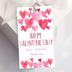 May include: A white gift tag with a pink and red watercolor heart design. The tag says "Happy Valentine's Day" and "Your friend, Madison".
