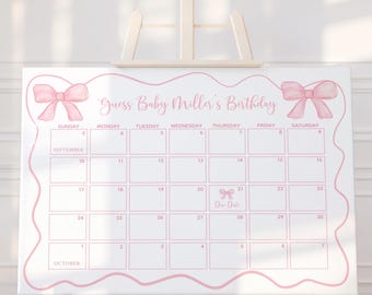 May include: A white calendar board with pink accents and the text "Guess Baby Miller's Birthday." The calendar grid is outlined in pink, with pink bow illustrations at the top corners. The calendar spans September and October.