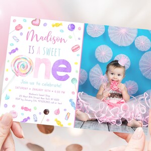 May include: A pink and purple birthday invitation with a photo of a baby girl holding a lollipop. The invitation says "Madison is a sweet one" and includes details for the party, including the date, time, and location.