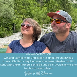 May include: Two people, a man and a woman, are standing in front of a river and green trees. The man is wearing a blue shirt, a baseball cap, and sunglasses. The woman is wearing a blue shirt and sunglasses. The text on the image reads: "Wir sind CAMPERLICH Wir sind Campervans und lieben es drau&szlig;en unterwegs zu sein. Die Natur inspiriert uns zu unseren Helden und ihr Schutz ist unser Antrieb. Schreibe uns bei FRAGEN gerne eine Nachricht oder rufe an. Bettina & MMS Schiemann"