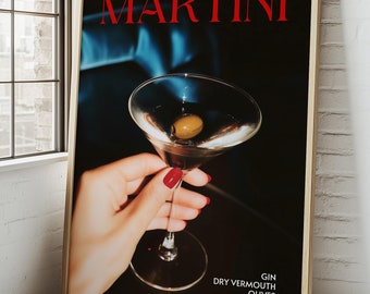 May include: A framed vertical poster featuring a martini glass with an olive, held by a hand with red nail polish. The text MARTINI appears in large red letters at the top, with GIN DRY VERMOUTH OLIVES printed in white at the bottom right corner.