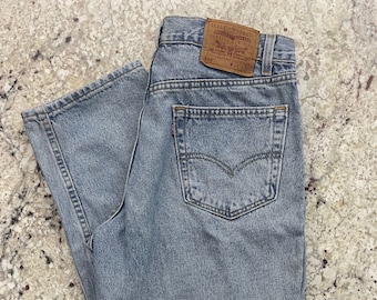 Waist 33 | Vintage 1980s Levi's 560 faded wash jeans. High waist. Tag 34 x 32.