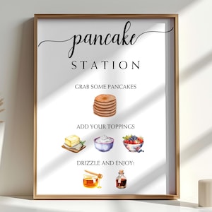 Op de afbeelding: Een ingelijste poster met de woorden "pancake station" in elegant schrift. De poster bevat illustraties van pannenkoeken, boter, slagroom, bessen, honing en siroop, met instructies.