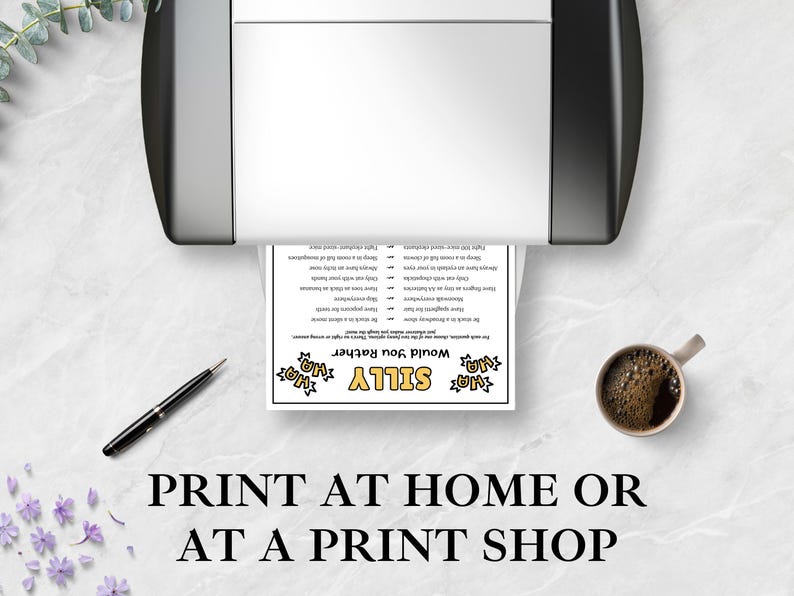 May include: A white paper sheet featuring a Silly Would You Rather game with black text and yellow accents, emerging from a black and white printer. A black pen and a ceramic mug filled with dark coffee are placed on the white marble surface.