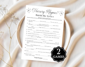 May include: A white paper game sheet titled "Nursery Rhymes finish the lyrics" with fill-in-the-blank questions. The sheet is on a white plate, with a sprig of dried flowers to the left. A black and white "2 GAMES" sticker is on the bottom right.