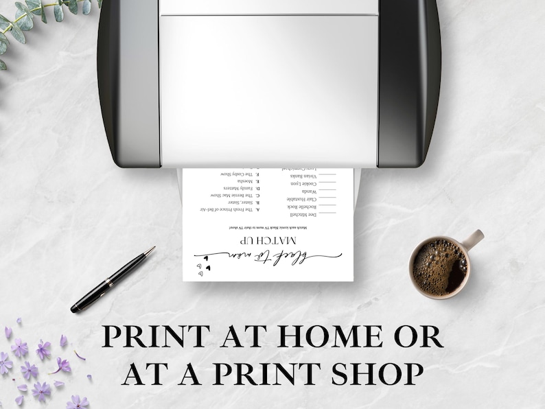 May include: A black and white printed game sheet is coming out of a printer. The sheet has the words "MATCH UP" and "black to mom" in cursive. A pen and a cup of coffee are on the table. The text "PRINT AT HOME OR AT A PRINT SHOP" is at the bottom.