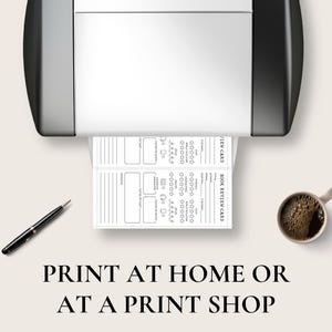 May include: A printer is shown with a printed book review card. A black pen and a cup of coffee are on the surface. The text "PRINT AT HOME OR AT A PRINT SHOP" is at the bottom of the image.