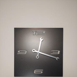 May include: Square wall clock with a carbon fiber-like background. The clock face features embossed numerals at 3, 6, 9, and 12 o'clock. The clock hands are designed as silver wrenches, adding a unique industrial touch to the decor.