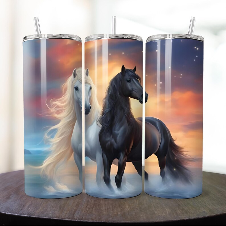 May include: Two stainless steel tumblers with a sunset background and a white horse and a black horse. The tumblers have lids and straws.