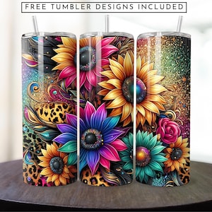 May include: Three stainless steel tumblers featuring a colourful floral design. The design includes sunflowers, pink and blue flowers, and leopard print accents. The tumblers have a glitter finish.