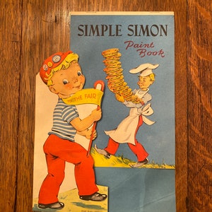May include: A vintage Simple Simon Paint Book featuring a boy holding a sign that says "To the Fair" and a chef carrying a stack of pancakes. The book is printed in the USA.