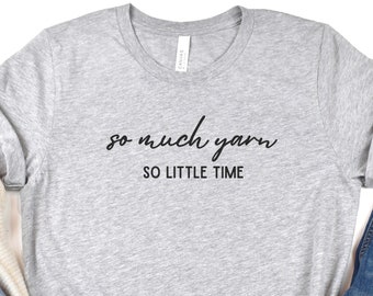 May include: Gray t-shirt with the text "so much yarn so little time" in black script font.