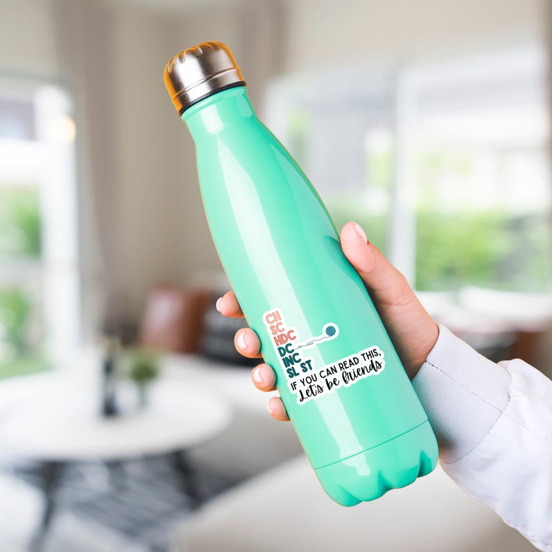 May include: A mint green insulated water bottle with a silver cap. A white sticker on the bottle reads "IF YOU CAN READ THIS, Let's be friends" with additional text. The bottle is held in a person's hand.