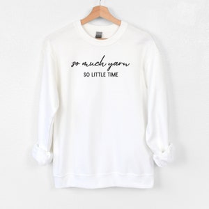May include: White sweatshirt with black text that reads "so much yarn so little time".
