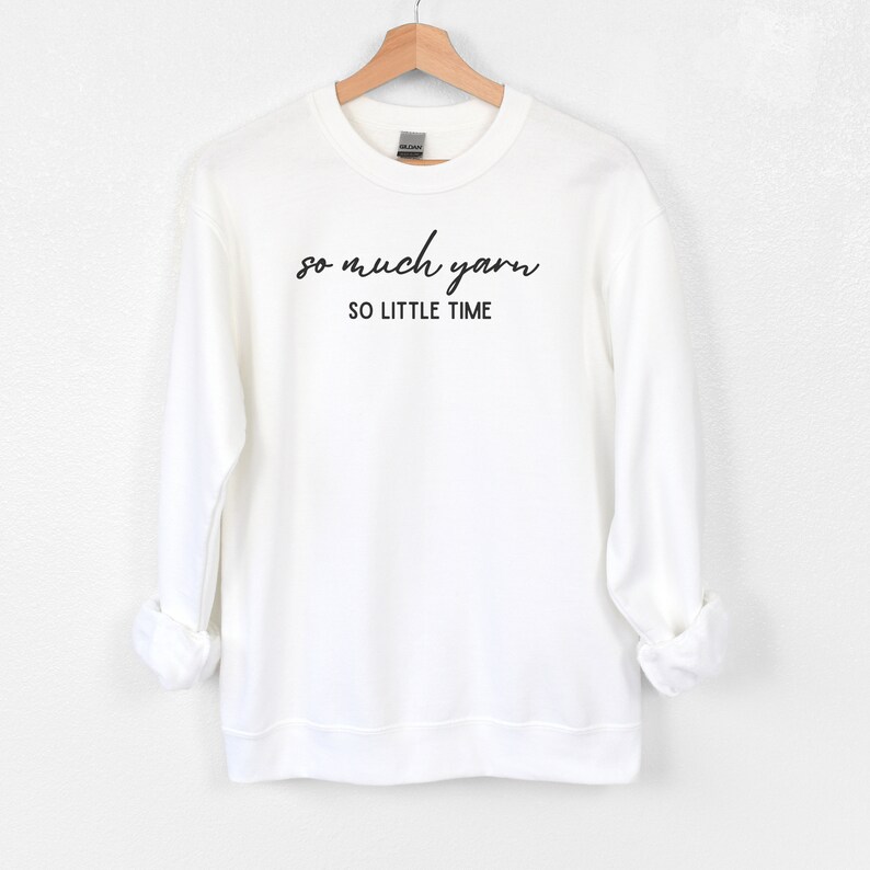 May include: White sweatshirt with black text that reads "so much yarn so little time".