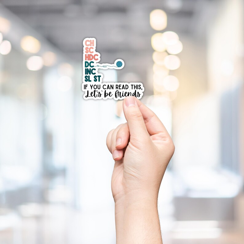 May include: A white sticker with the text "CH, SC, HDC, DC, INC, SL ST" in various colors, with a small crochet hook and yarn design. Below, the sticker reads "IF YOU CAN READ THIS, Let's be friends."