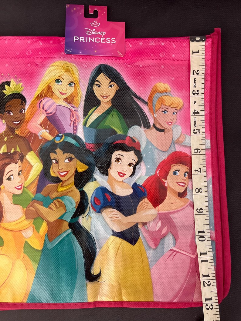 May include: A white ceramic mug with a black handle and the text "But First, Coffee" in a bold, black font. The mug is sitting on a wooden surface. The mug is approximately 4 inches tall.