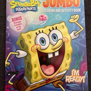May include: A Jumbo coloring and activity book featuring SpongeBob SquarePants. The cover shows a large, smiling SpongeBob with the words "I'm Ready!" and "Jumbo Coloring and Activity Book." Includes bonus character bracelets on the back.