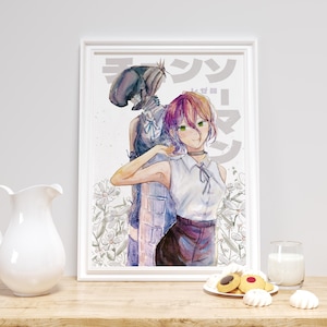 May include: A framed watercolour print depicting two anime-style characters. One character has pink hair and a white top, the other has a dark hat and vest. The print has Japanese text and is set against a floral background. A white jug, glass of milk, and biscuits are on the table.
