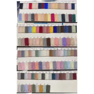 May include: A color chart of 100 different shades of tulle fabric. The chart is divided into rows of 10 swatches each. The swatches are numbered from 1 to 100.