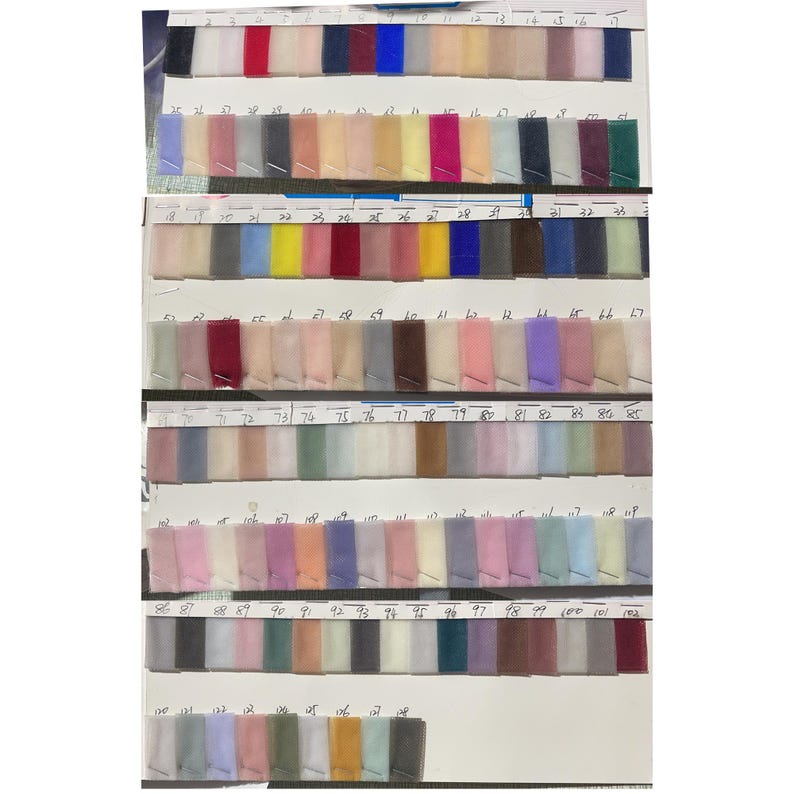 May include: A color chart of 100 different shades of tulle fabric. The chart is divided into rows of 10 swatches each. The swatches are numbered from 1 to 100.
