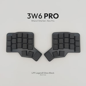May include: A black split ergonomic keyboard with the text 3W6 PRO Where It Started - Now Pro. and LPF Legend Glow Black Black Case. The keyboard features two separate sections with black keys arranged in a non-standard, contoured layout.