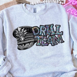 May include: Gray sweatshirt with a black and white image of a hat with rhinestones and the words "DRILL TEAM" in rhinestones.