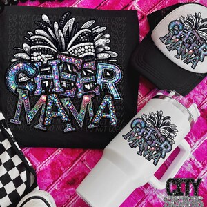 May include: A white tumbler with a black and white glitter design that says "Cheer Mama". The tumbler has a handle and a lid. The design is also on a black t-shirt and a black trucker hat.