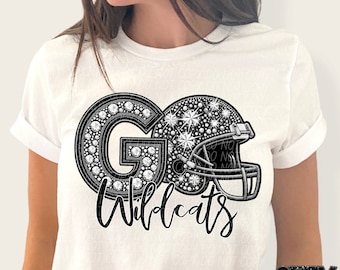 May include: White t-shirt with a black and white design of a football helmet and the words "Go Wildcats" with rhinestones.