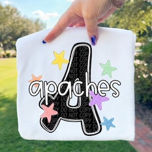 May include: White sweatshirt featuring the word "apaches" in a playful font, with a large black letter "A" as the focal point. Colorful star accents in yellow, orange, pink, green, purple, and blue surround the text, creating a cheerful design.