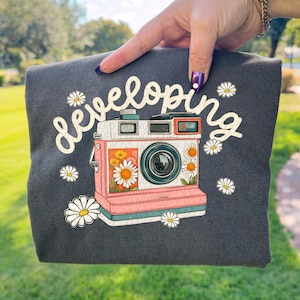 May include: A handmade wooden sign with the text "Welcome" in a playful font. The sign features a distressed, rustic finish and a simple, inviting design. Perfect for a front door or entryway.