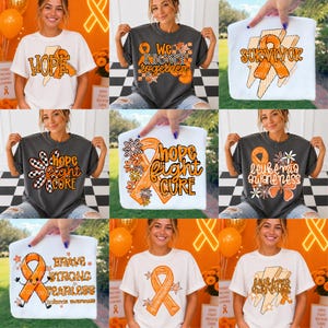 Könnte beinhalten: Eine Kollektion von neun T-Shirts mit orangefarbenen Awareness-Schleifen und verschiedenen grafischen Designs mit Texten wie Hope, We Fight Together, Survivor, Hope Fight Cure, Leukemia Awareness und Brave Strong Fearless in Orange und Schwarz.