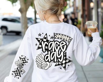 May include: White sweatshirt with a black and white graphic design on the back. The design features a checkered flag, stars, wings, and the text "race day".