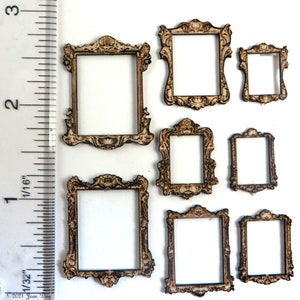 May include: Seven miniature wooden picture frames with ornate, vintage-style designs. The frames are various sizes, with detailed carvings and a light brown colour. A ruler is in the image, showing measurements.