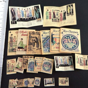May include: A collection of vintage fashion magazines, including "La Mode Francaise", "Le Petit Echo", and "Mon Ouvrage". The magazines feature illustrations of women's clothing and accessories from the early 20th century.