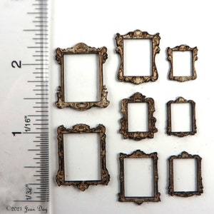 May include: Set of seven unfinished wooden picture frames in various sizes. The frames have a decorative, ornate design. The frames are approximately 1 inch in size.