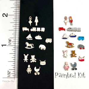 May include: A set of 20 miniature wooden toys, painted in various colors, including a rocking horse, a train, a sailboat, a doll, a teddy bear, a drum, a stroller, and a car. The toys are arranged in two rows on a black and white background. The text "Painted Kit" is visible in the lower right corner of the image.