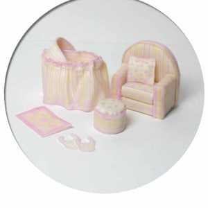 May include: A miniature nursery set with a yellow and pink striped crib, a matching armchair with a polka dot pillow, a small ottoman, a pink and yellow striped rug, and a pair of pink baby booties.
