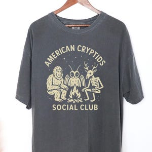 Cryptid Camping Graphic Tee, Bigfoot Mothman Wendigo Unisex Shirt, Mythical Creature Outdoors T-shirt, Sasquatch Folklore Hiking Top